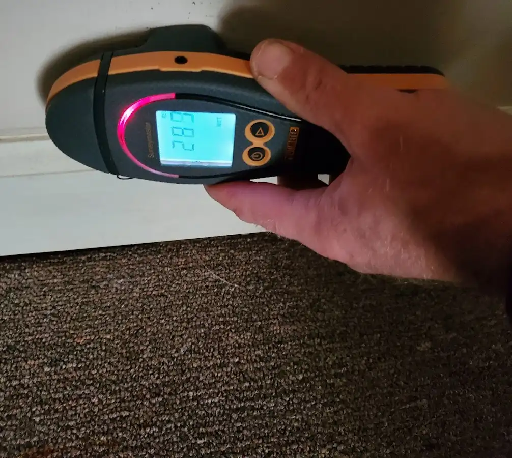 Moisture detection at baseboard during Storm Damage Restoration in Bridgetown